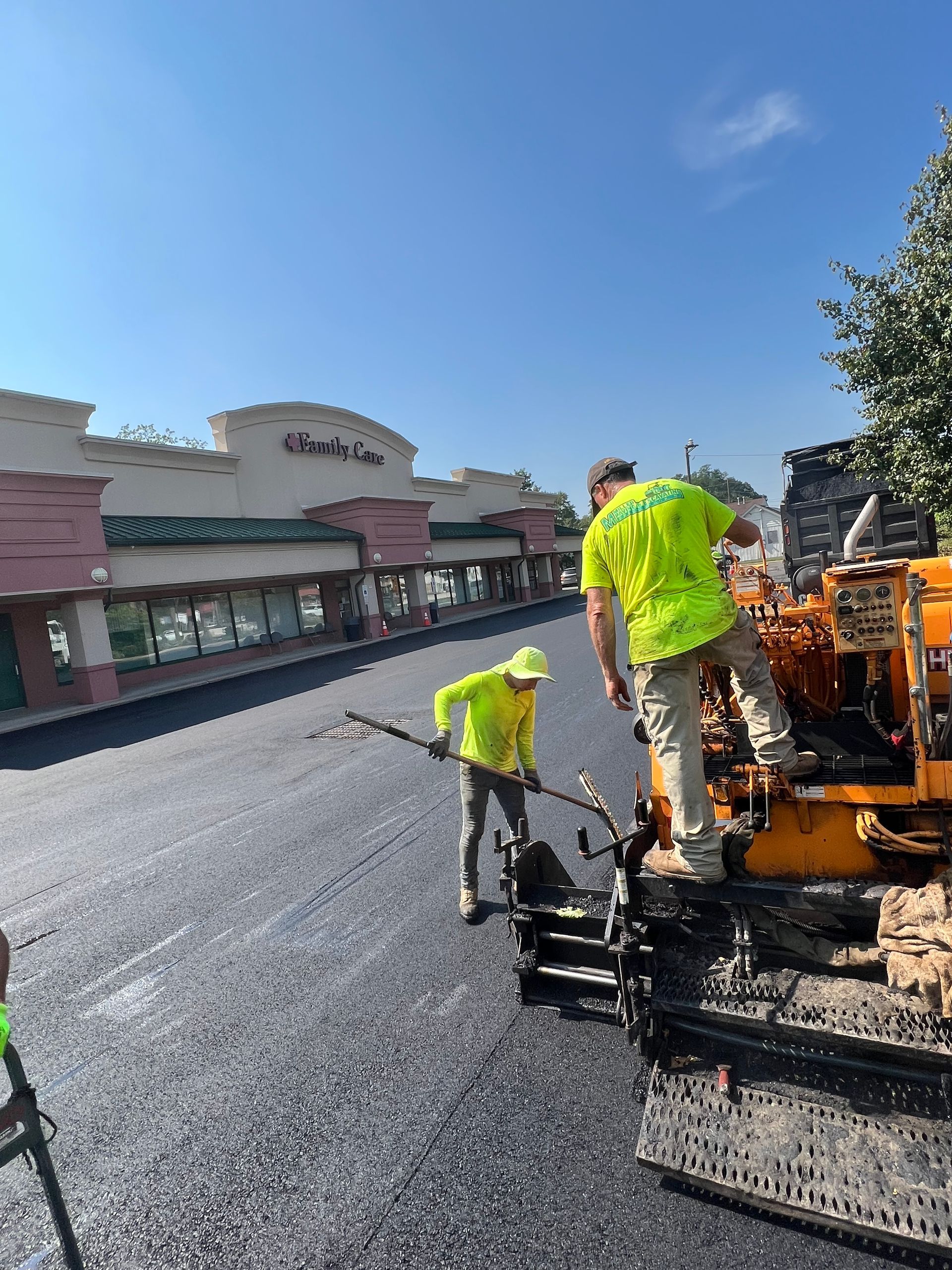 A group of construction workers are working on a road.