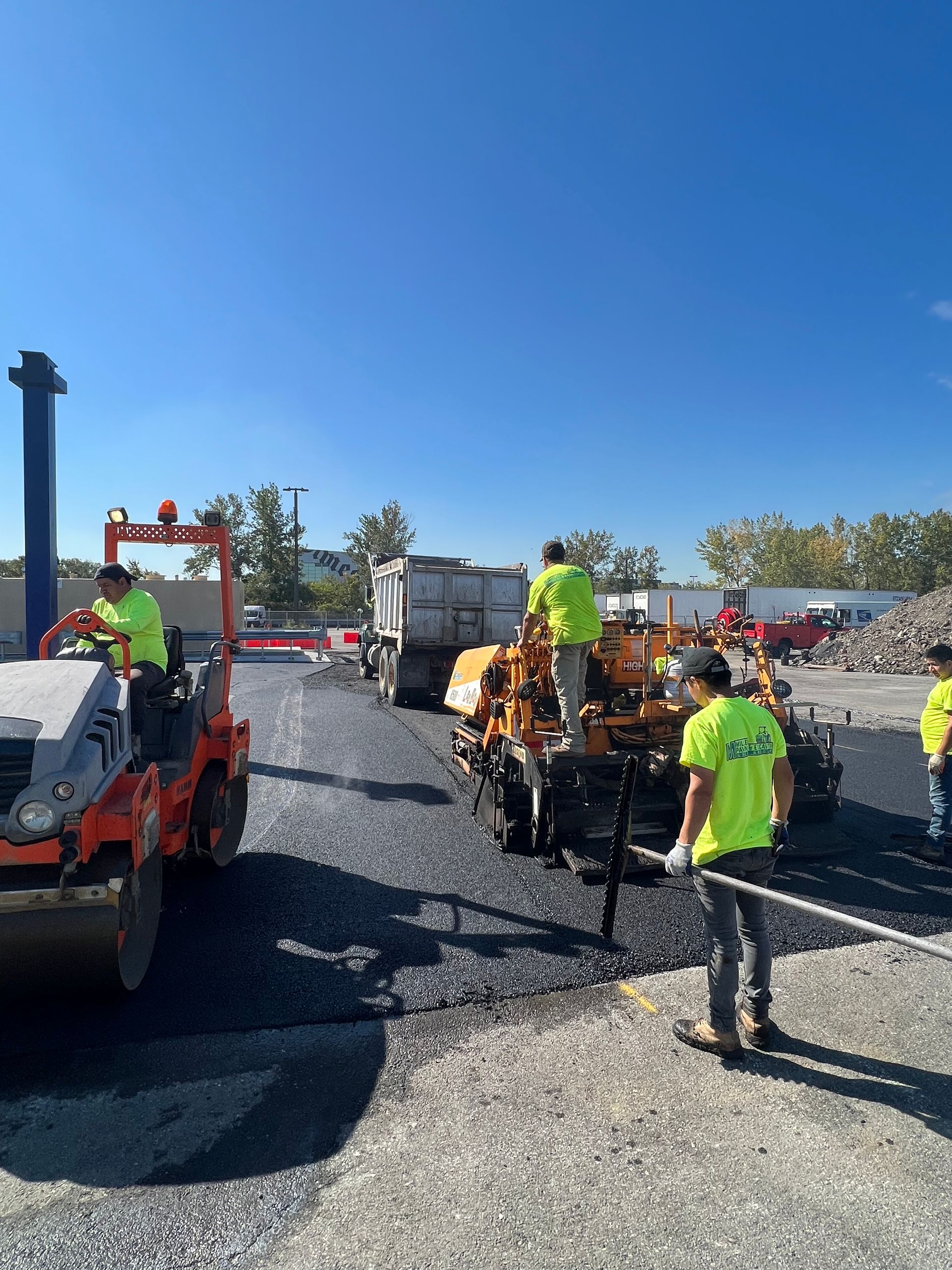 A group of construction workers are working on a road.
