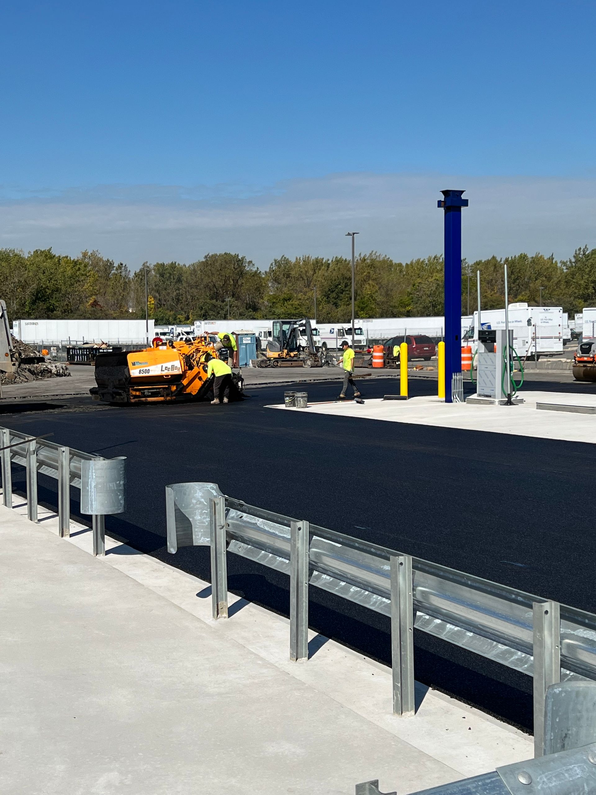 A construction site with a blue pole that says 1 on it