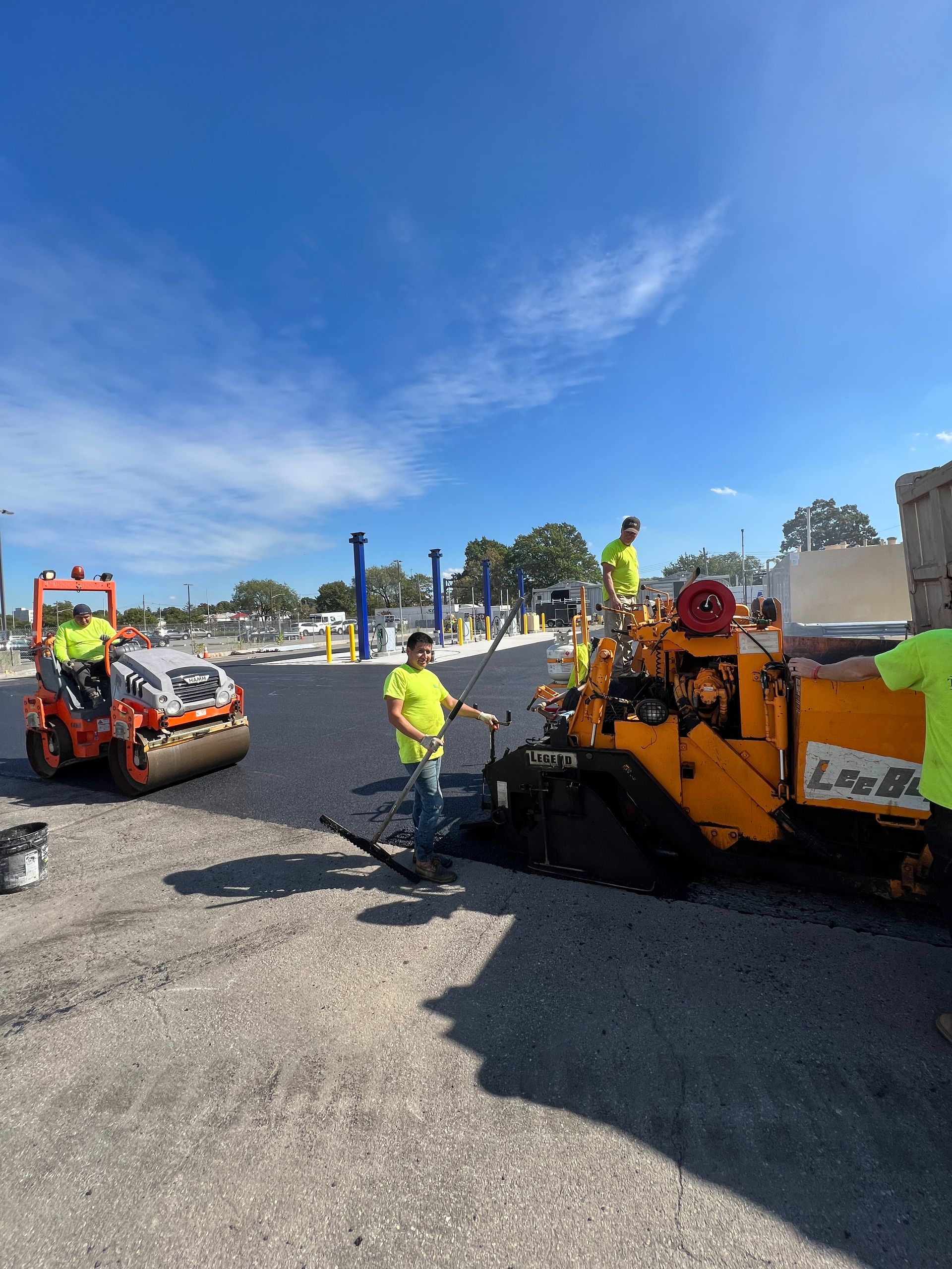 A group of construction workers are working on a road