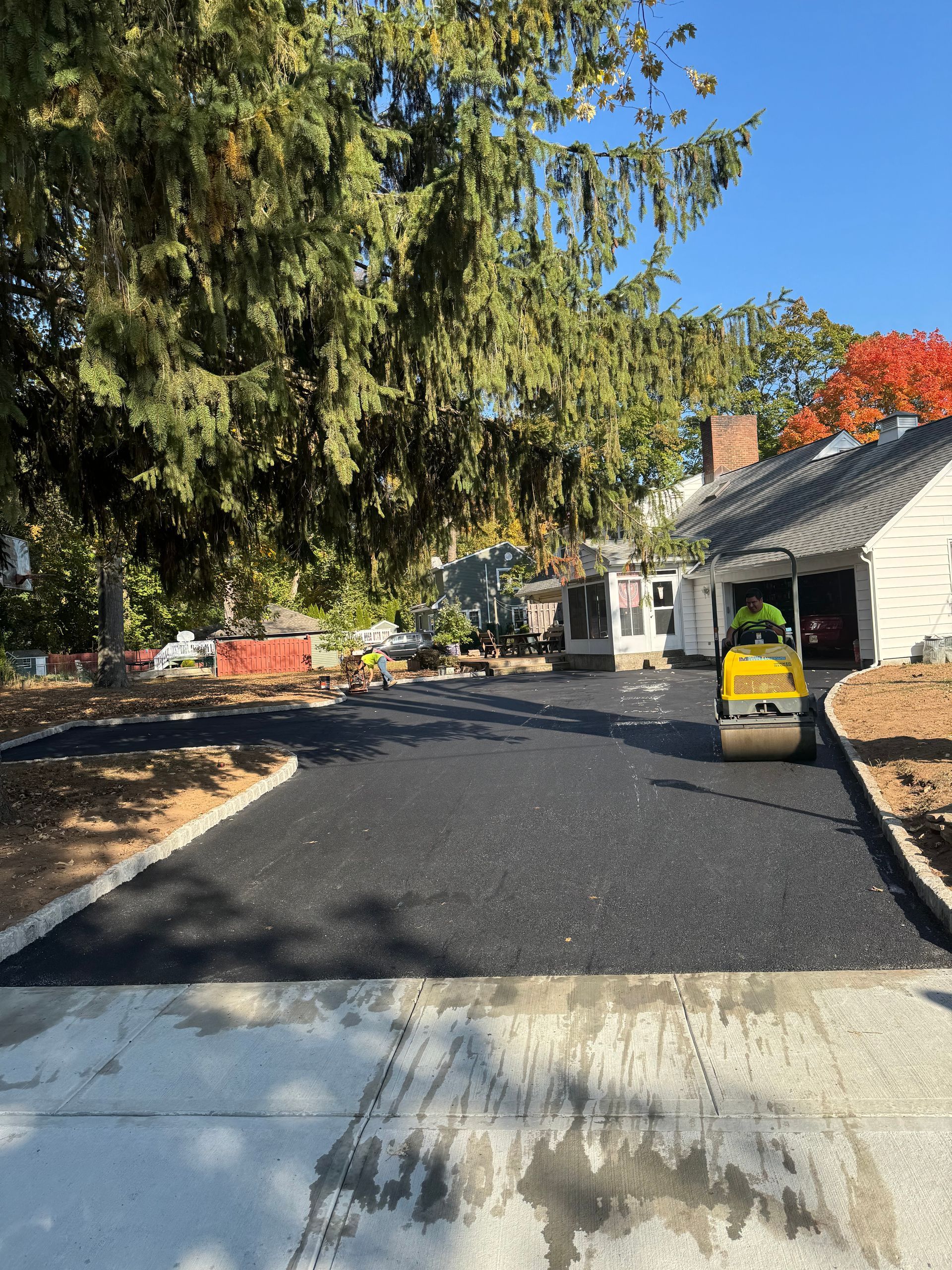 A road is being paved in front of a house.