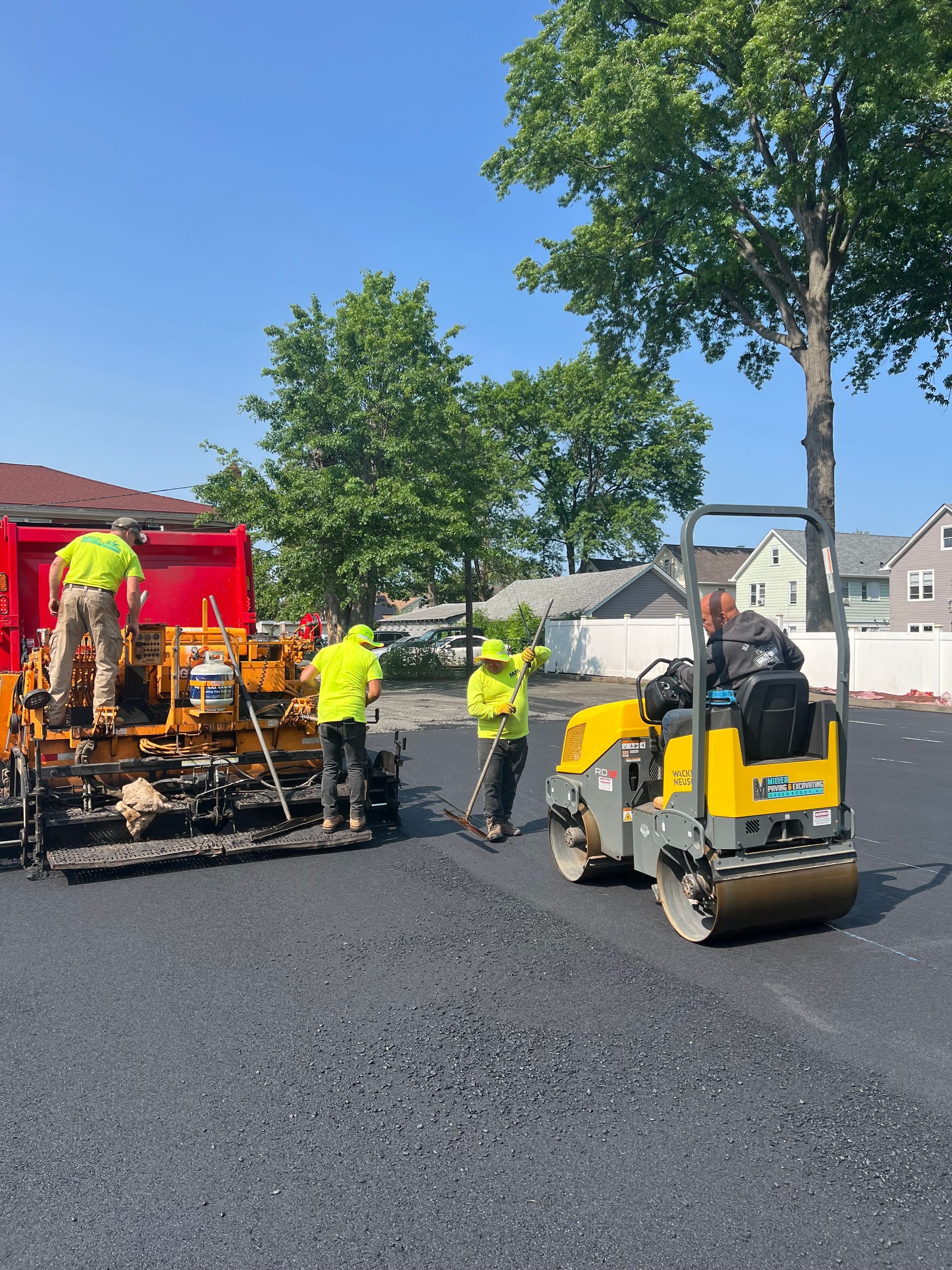 A group of construction workers are working on a road.