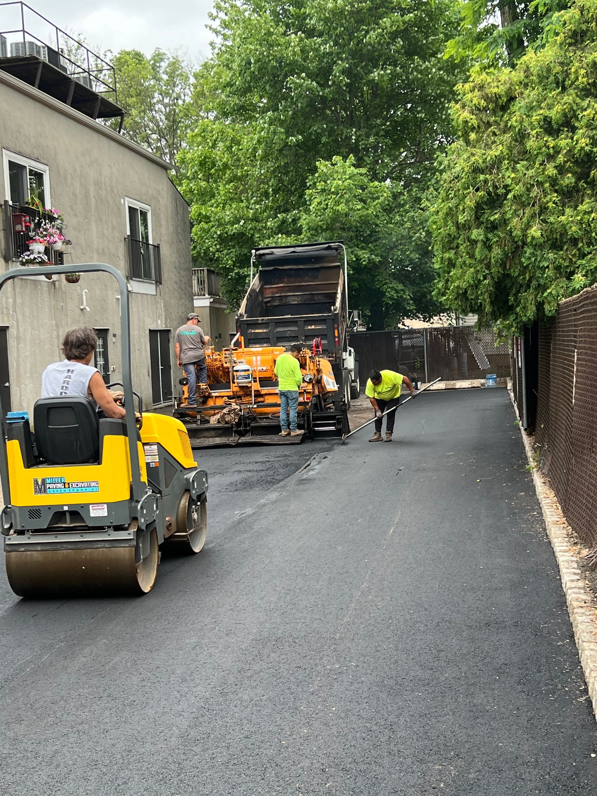 A man is driving a yellow roller down a street.