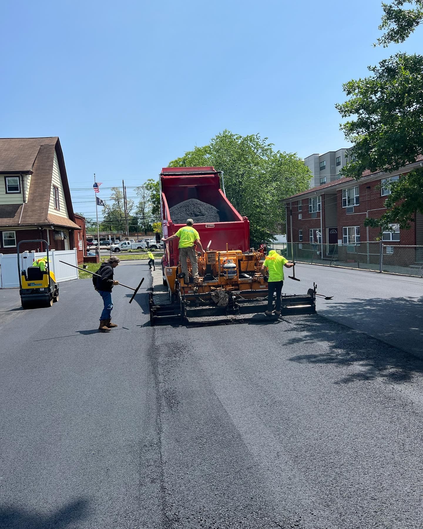 A group of construction workers are working on a road