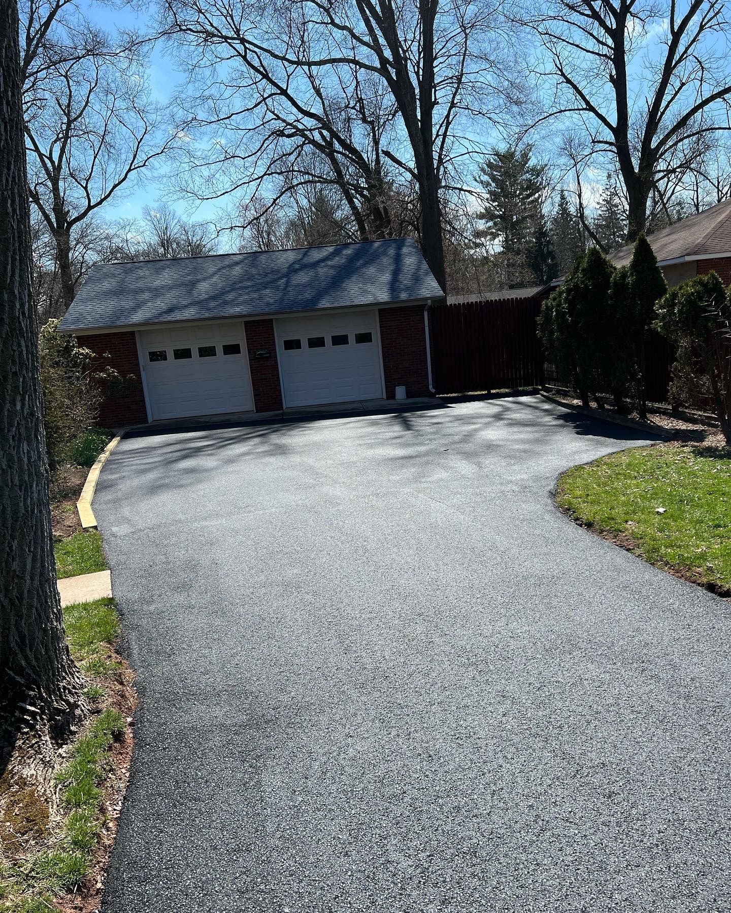 A driveway leading to a garage and a house.