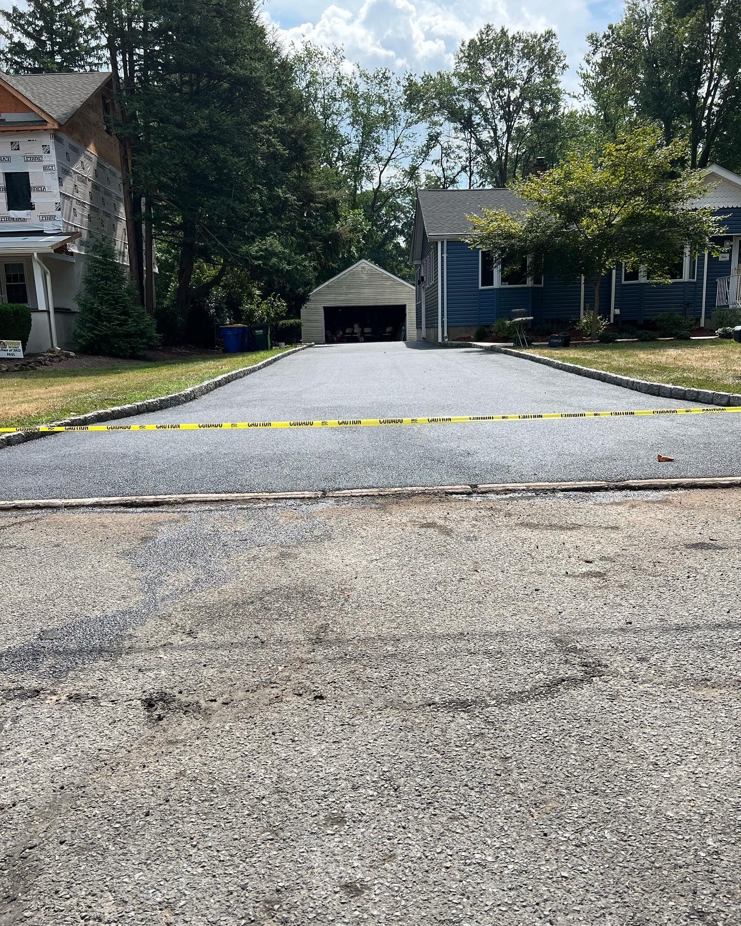 A driveway is being built in front of a house.
