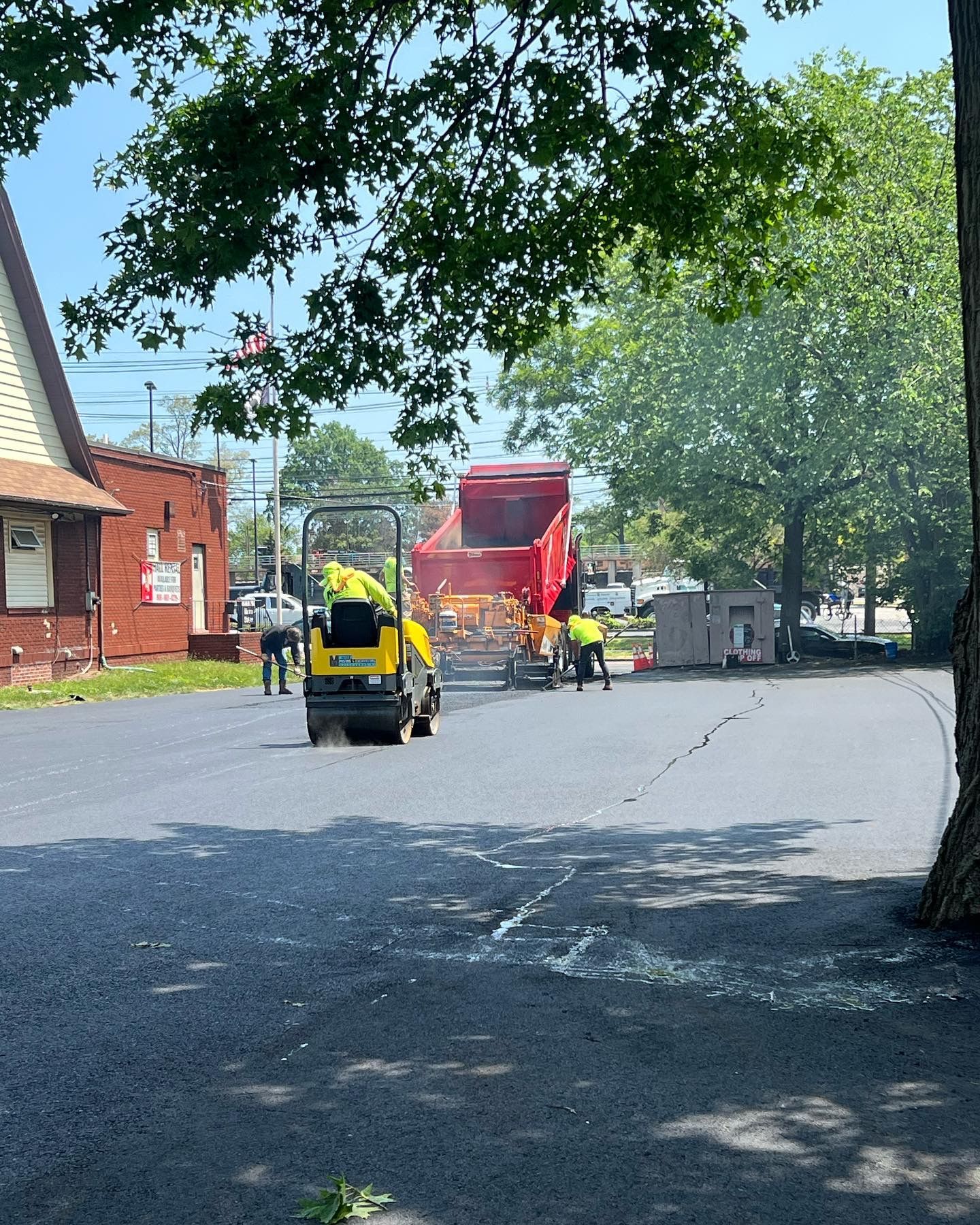A yellow and red truck is driving down a street