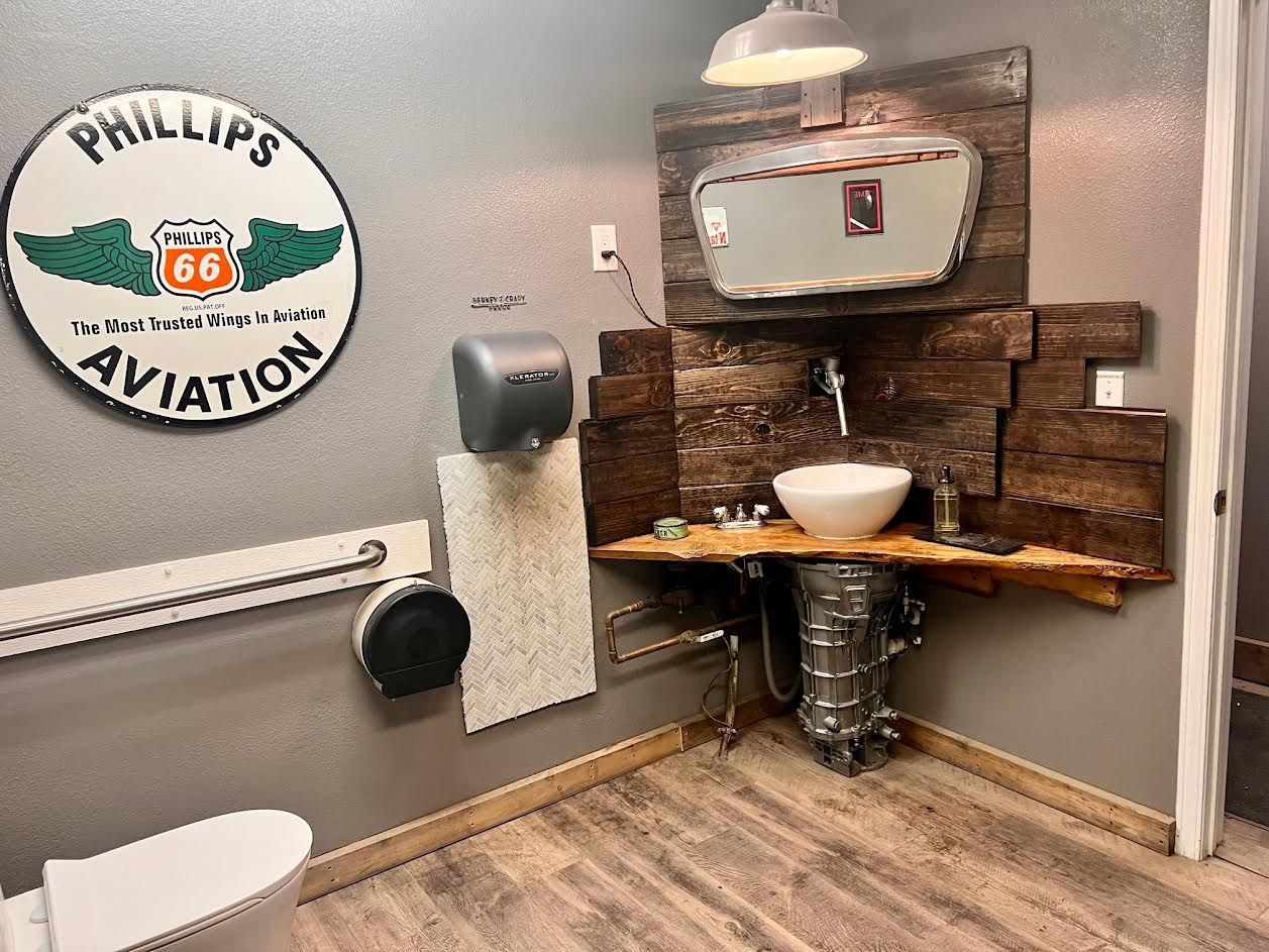 Bathroom with a sink, toilet and a sign that says Philips aviation.