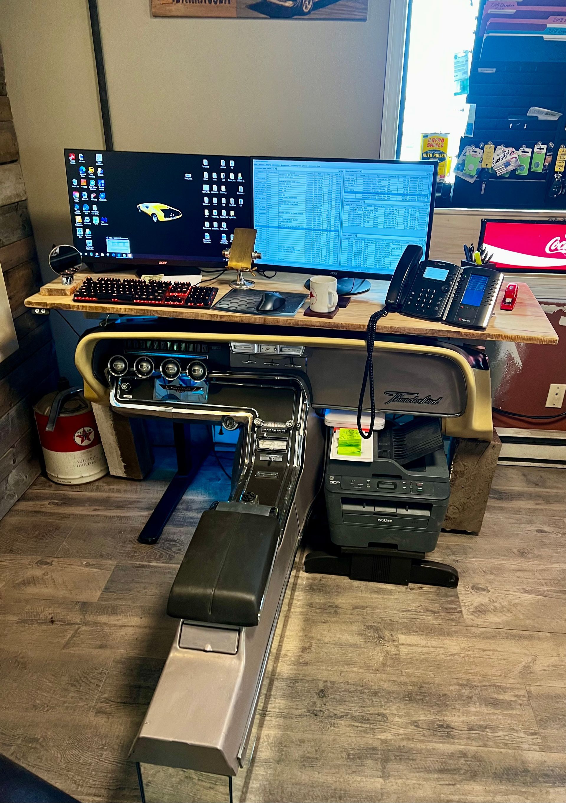 A computer desk with two monitors and a phone on it.