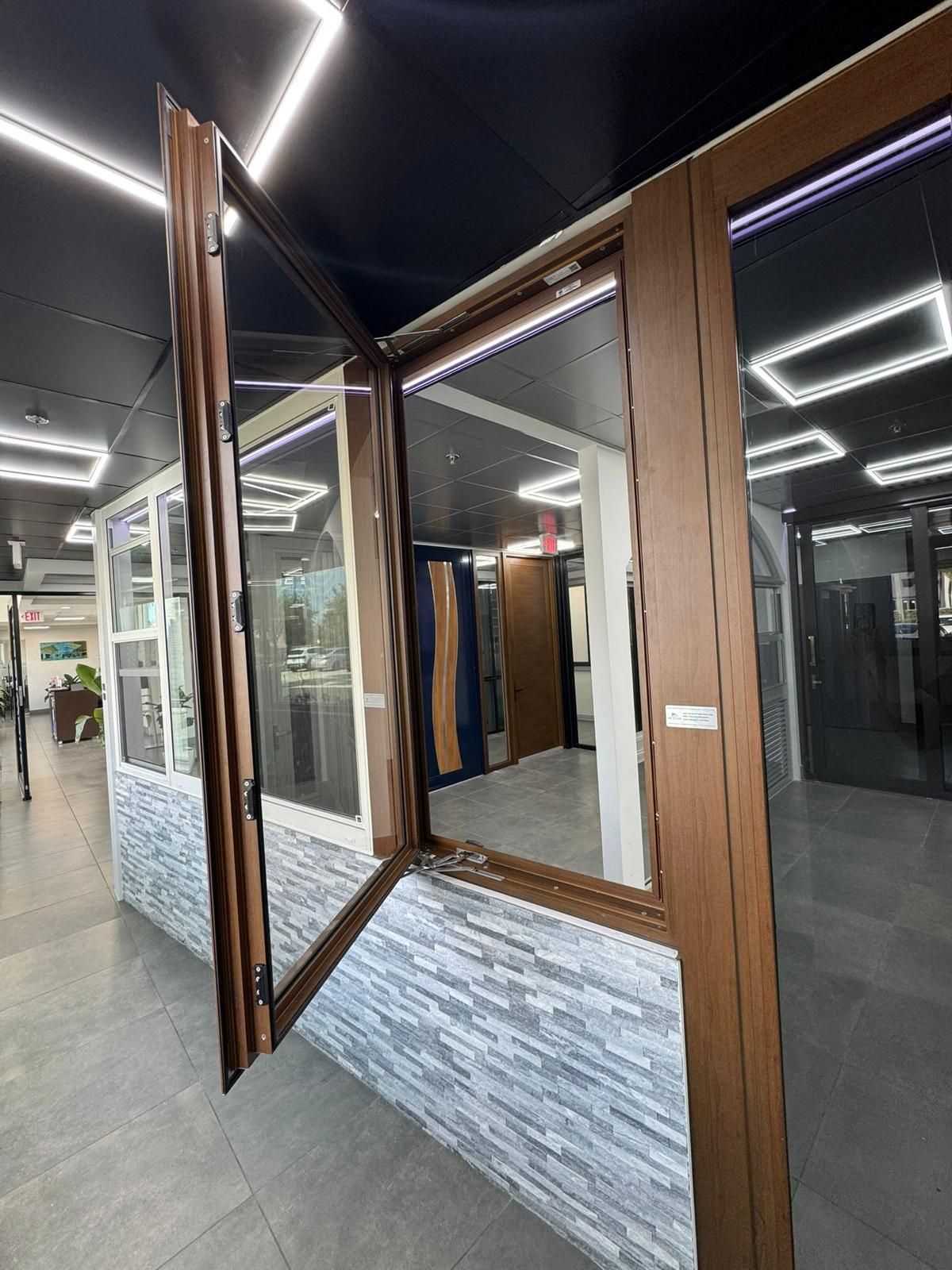 Opened brown window display in a showroom. Light reflects on the glass.