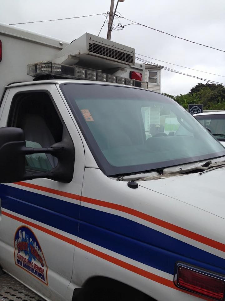 a white and blue ambulance with the word ambulance on the side