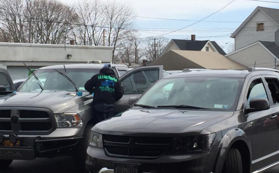 a man is standing next to a dodge ram truck in a parking lot