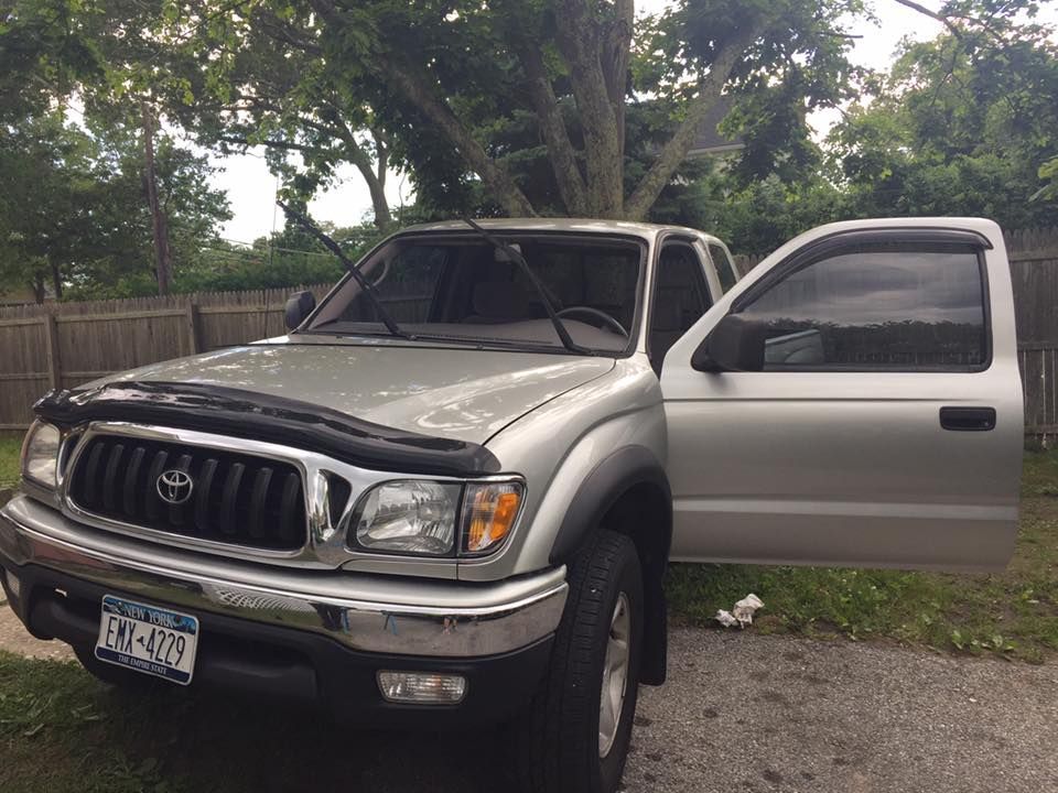 a silver toyota tacoma truck with its doors open