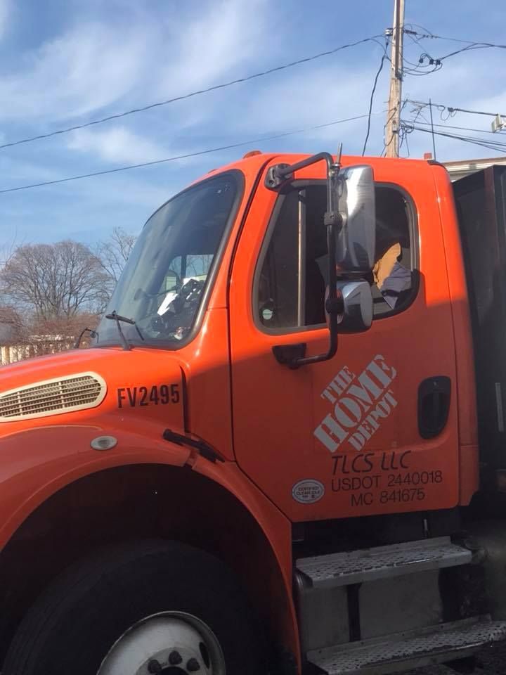 an orange home depot truck is parked on the side of the road