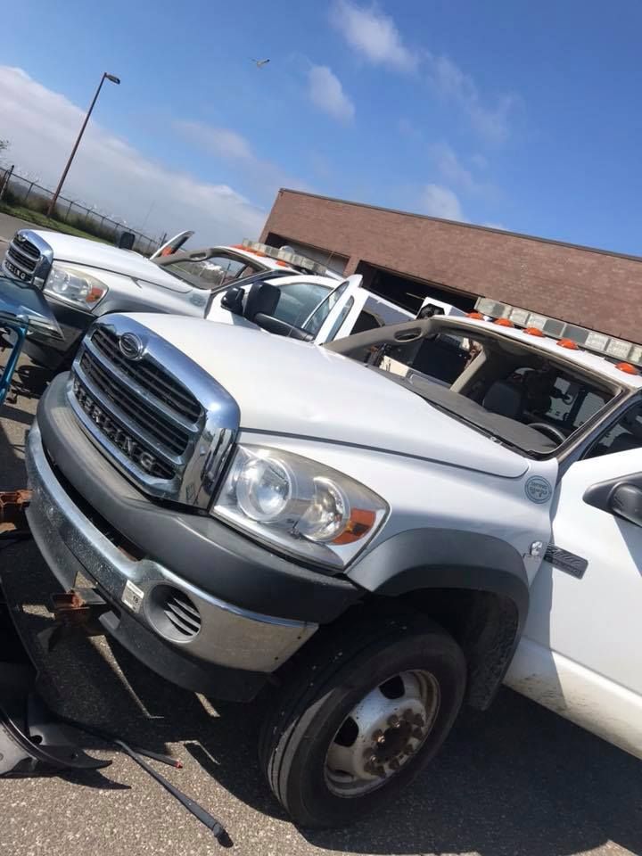 a row of tow trucks are parked in front of a building