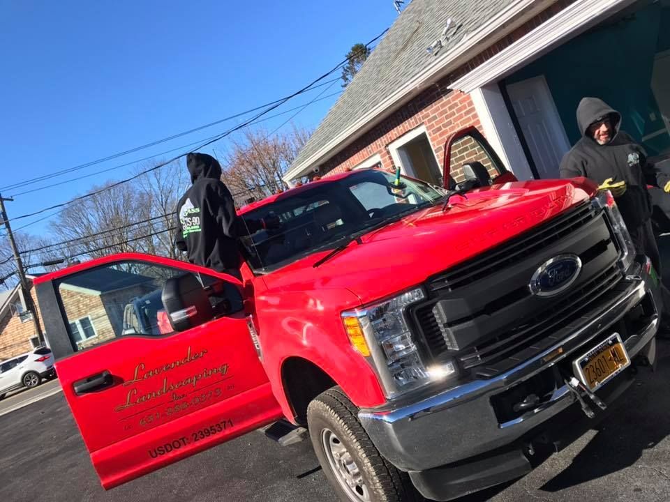 a red ford truck is parked in front of a garage