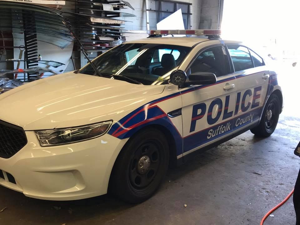 a white and blue police car is parked in a garage