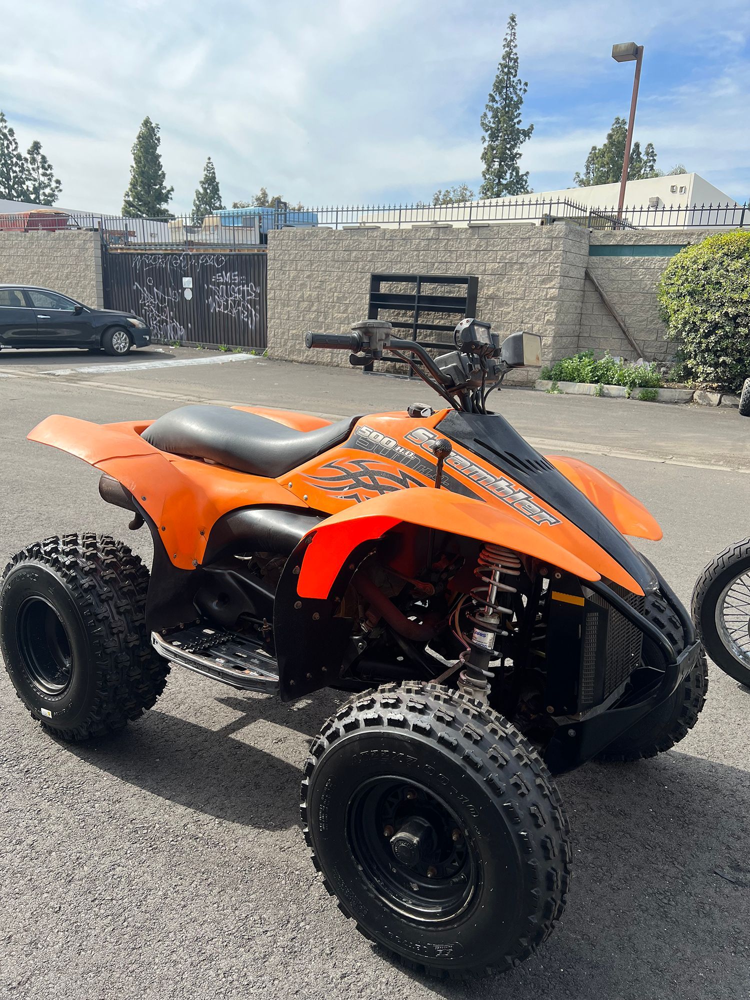 Orange ATV parked outdoors.