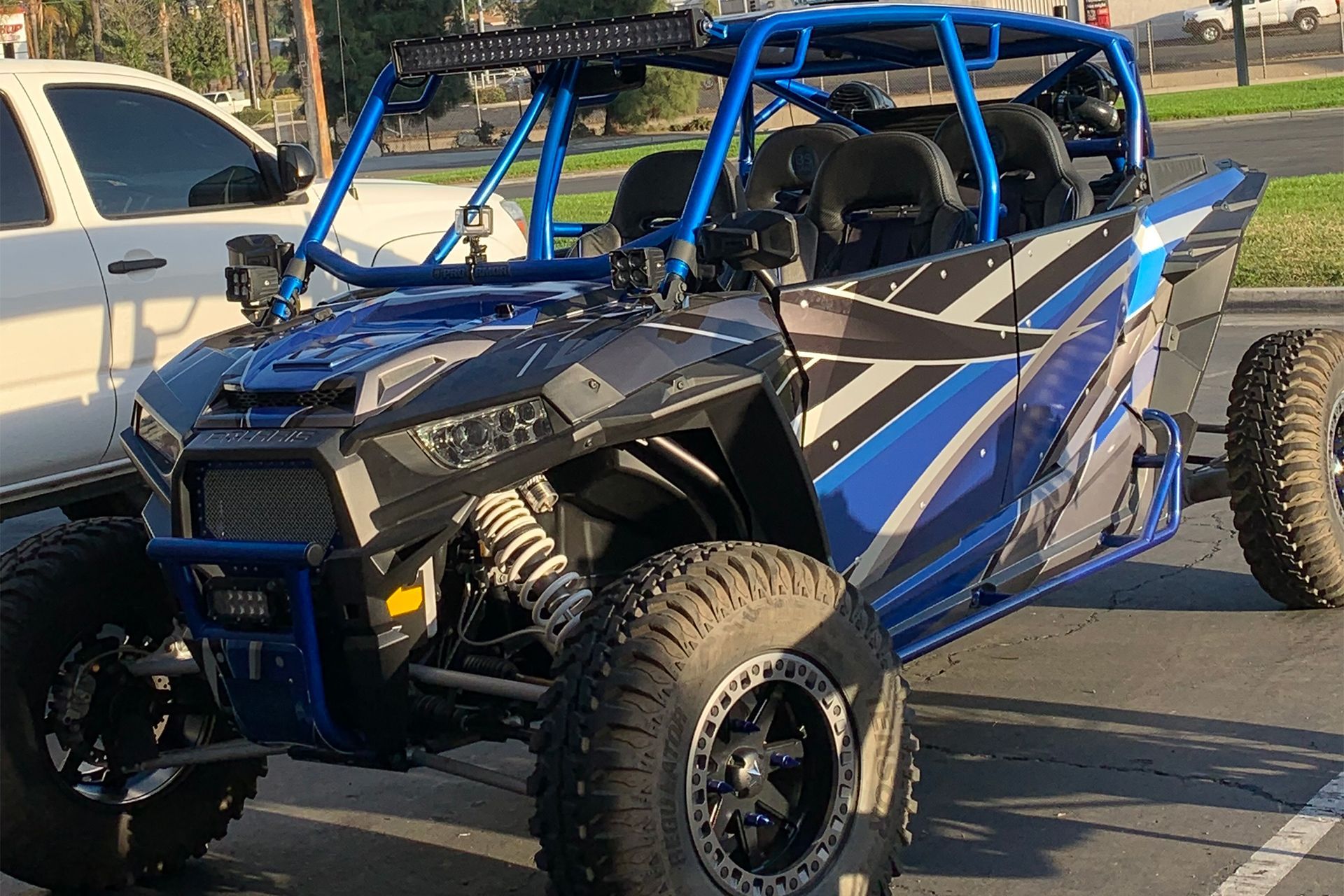 Dark blue Harley-Davidson motorcycle parked in a lot, chrome details, white wall tires.