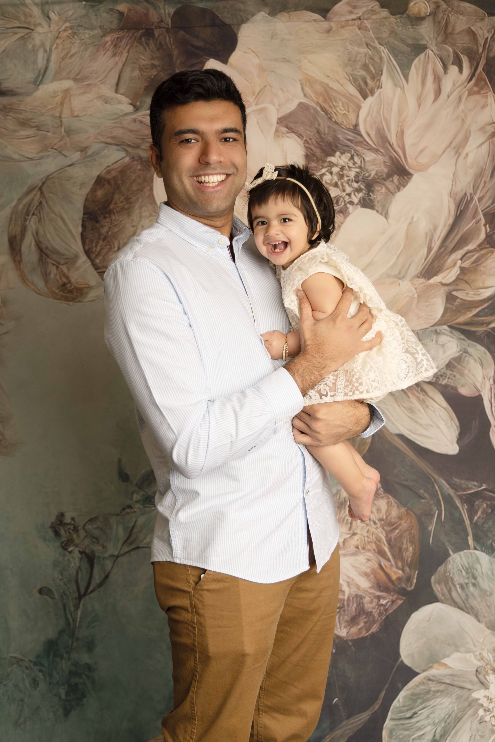 A family is posing for a picture in the grass.