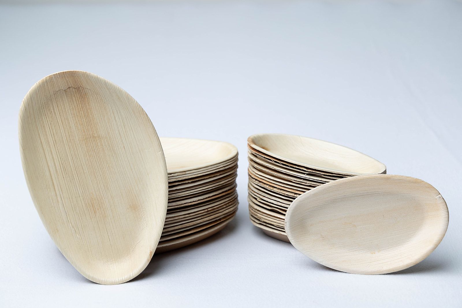 A stack of wooden plates and bowls on a table