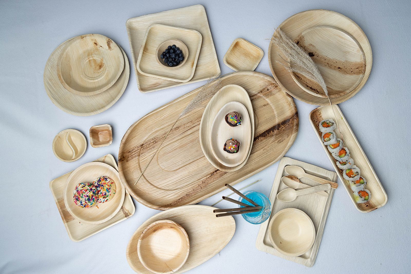A variety of wooden plates and bowls are sitting on a table.
