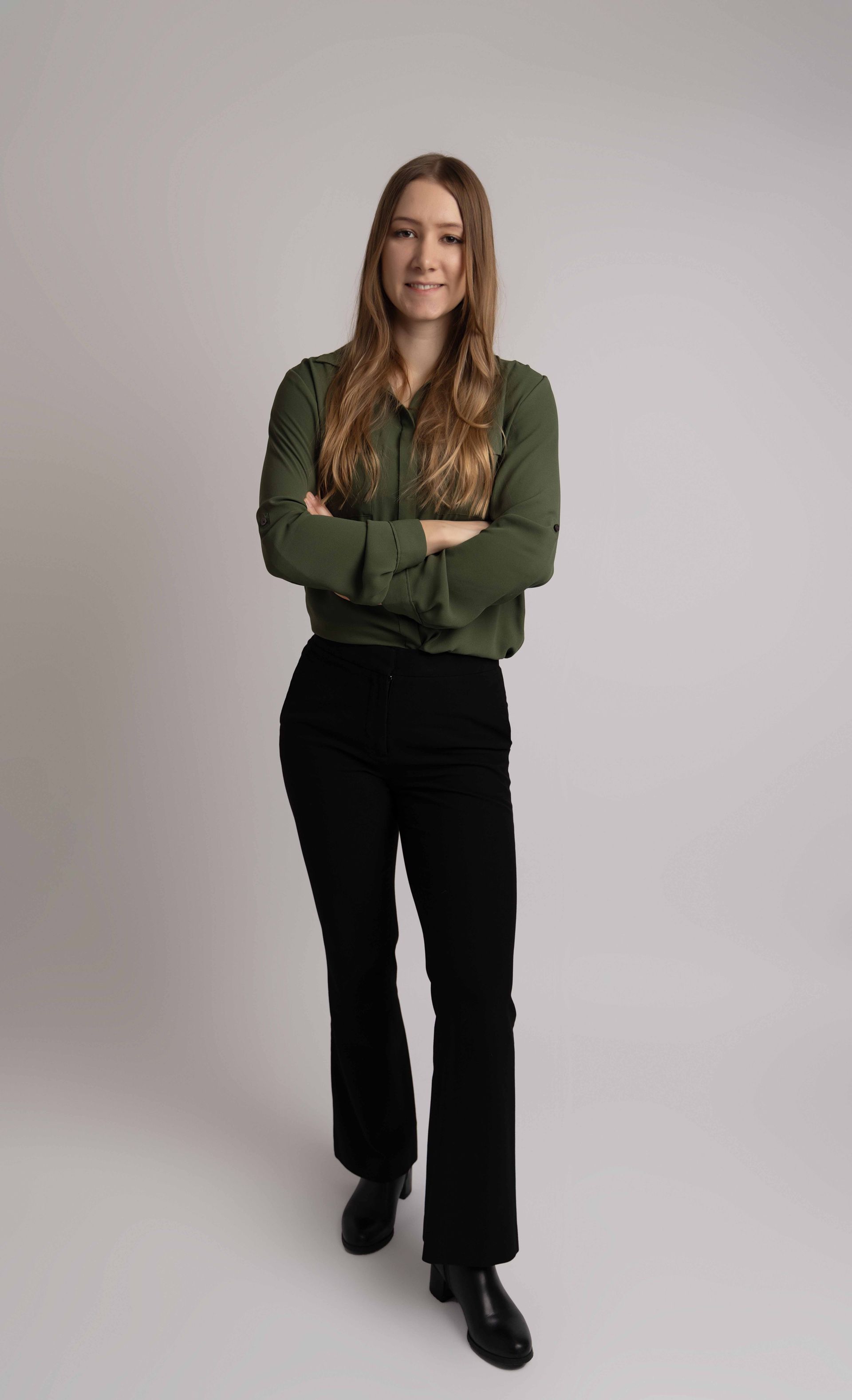 A woman in a green shirt and black pants