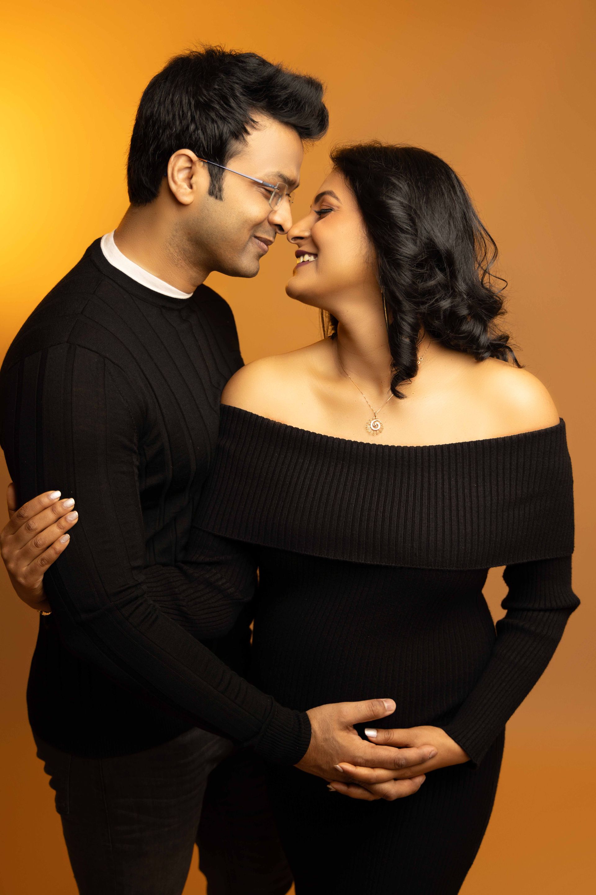 A man and a pregnant woman are looking at each other.