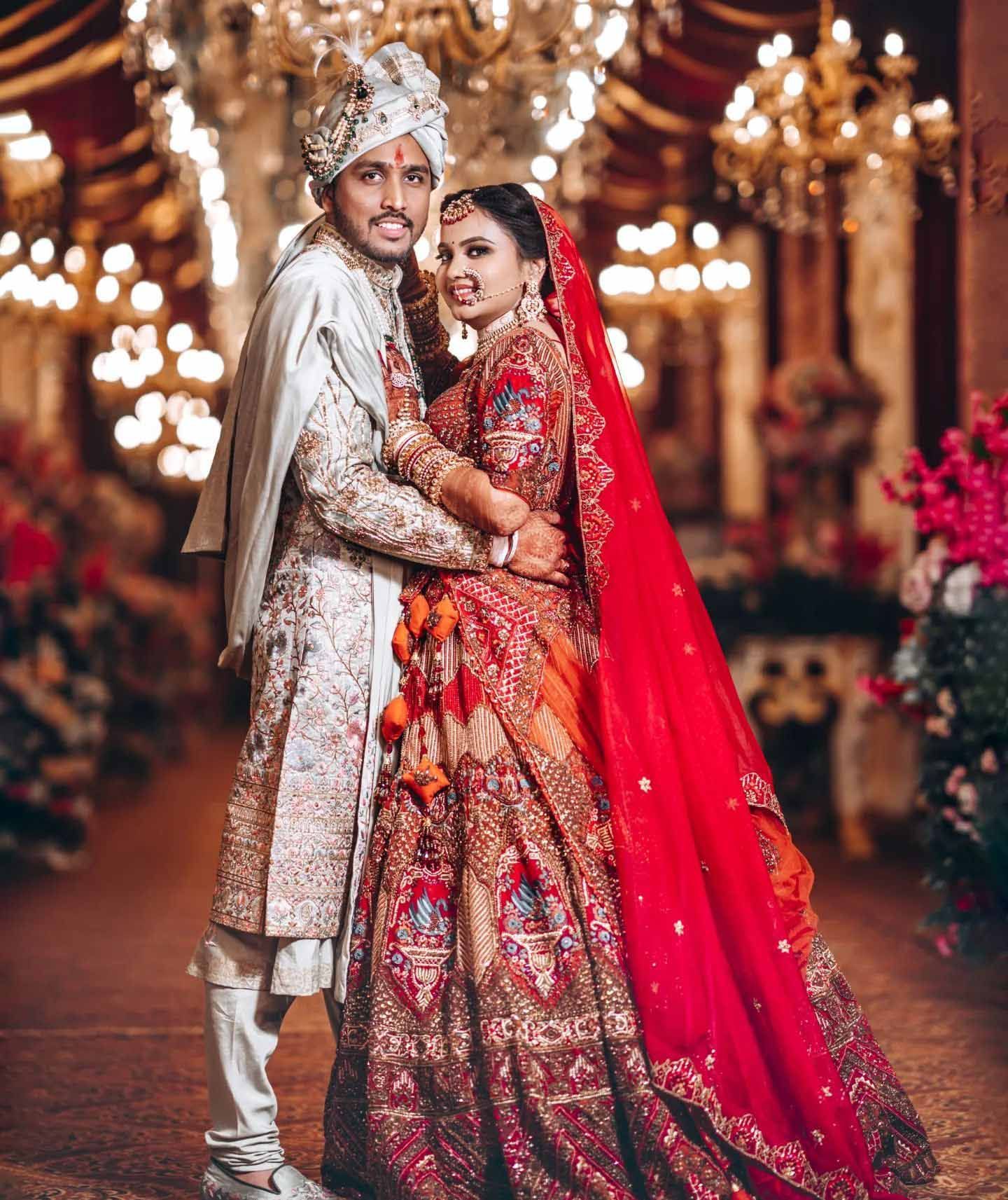 A bride and groom are posing for a picture on their wedding day.