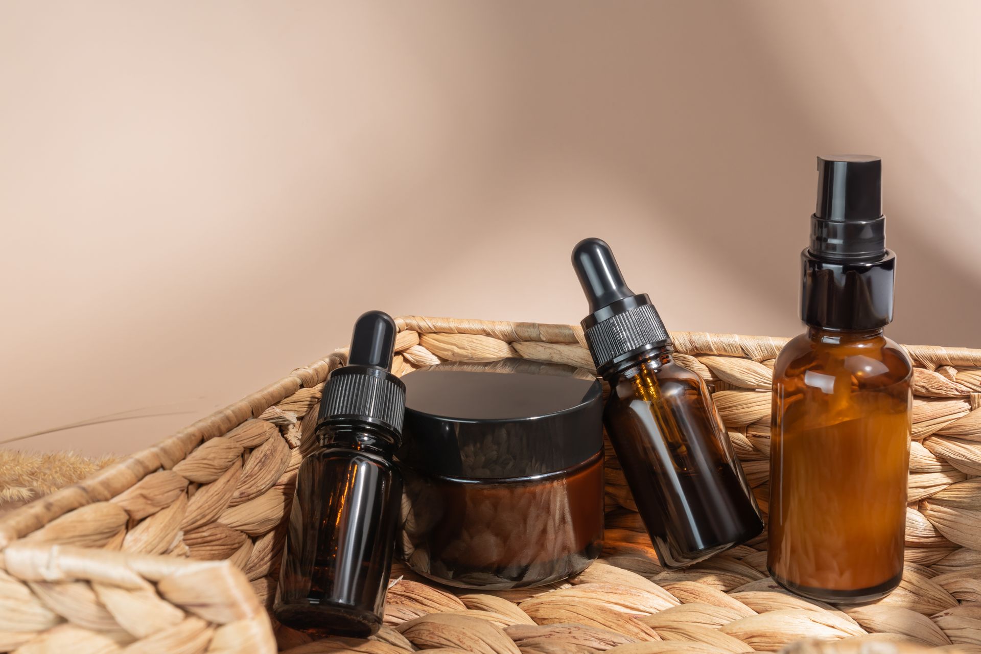 A wicker basket filled with bottles and jars of cosmetics.