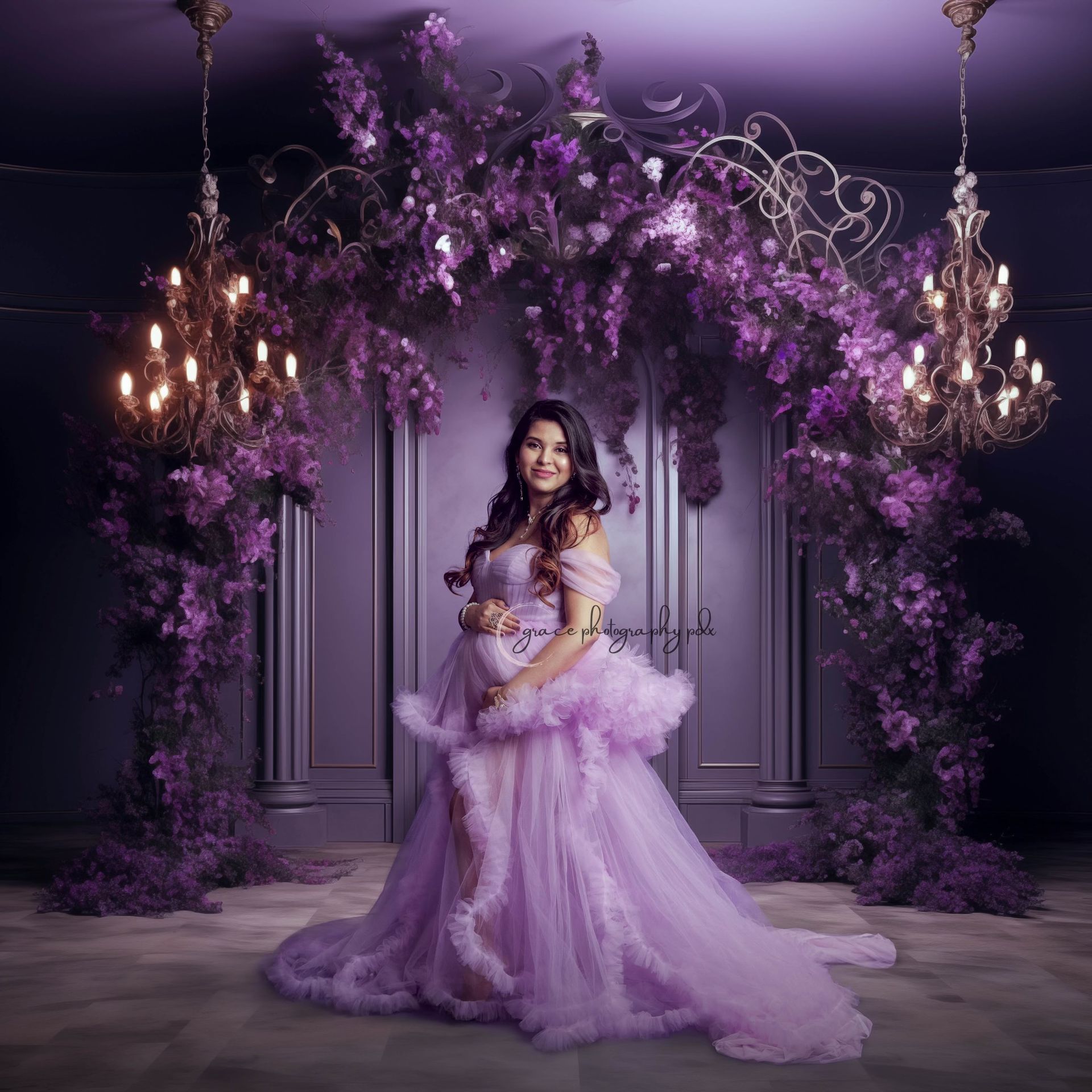 A pregnant woman in a purple dress is standing in front of purple flowers.