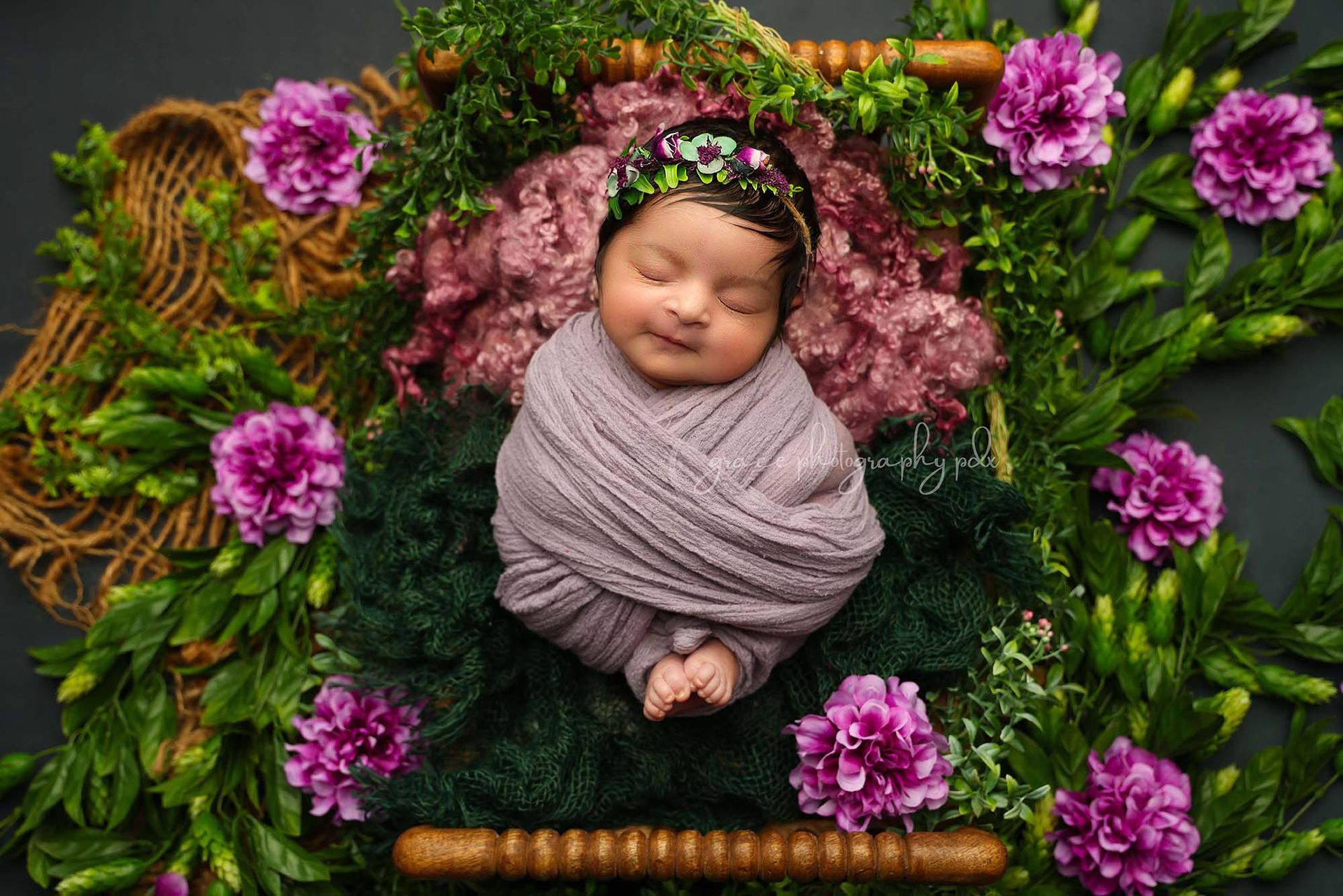 Sleeping newborn baby in a basket with decorations