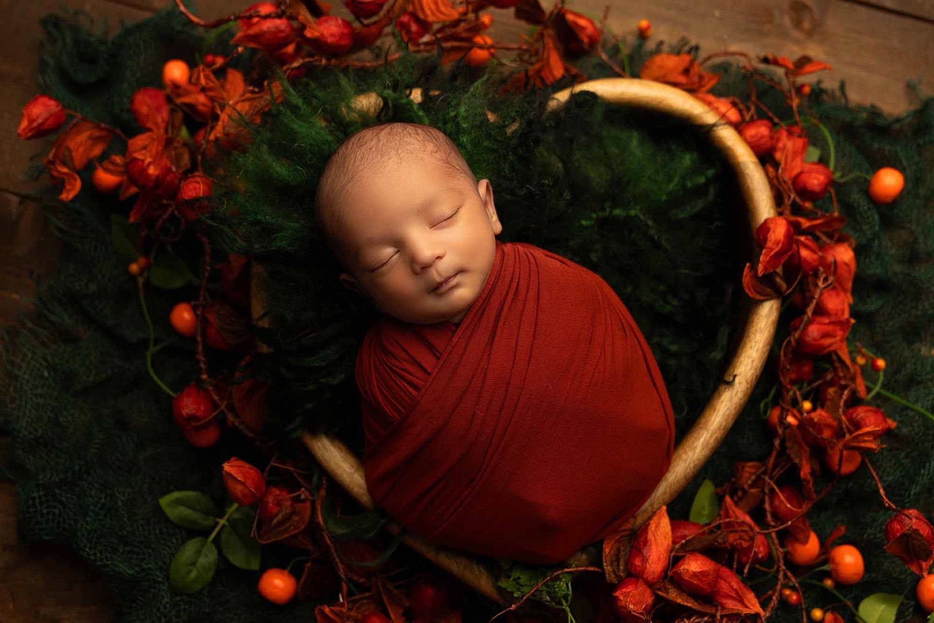 Newborn baby sleeping in a heart-shaped background