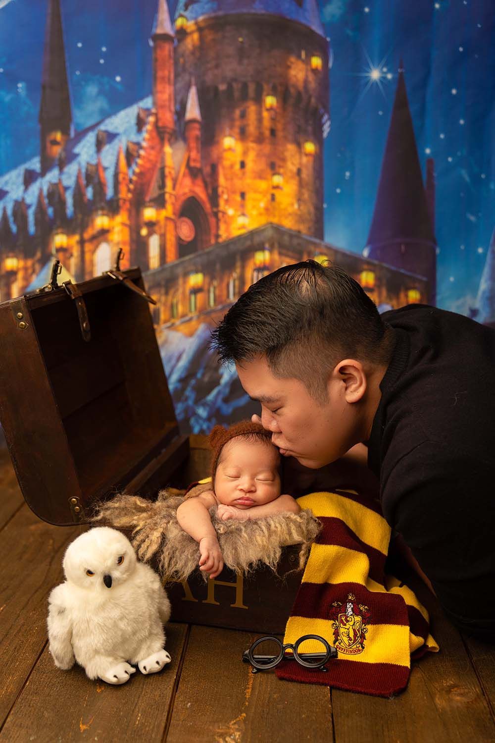 Father kissing his baby in a mini treasure chest