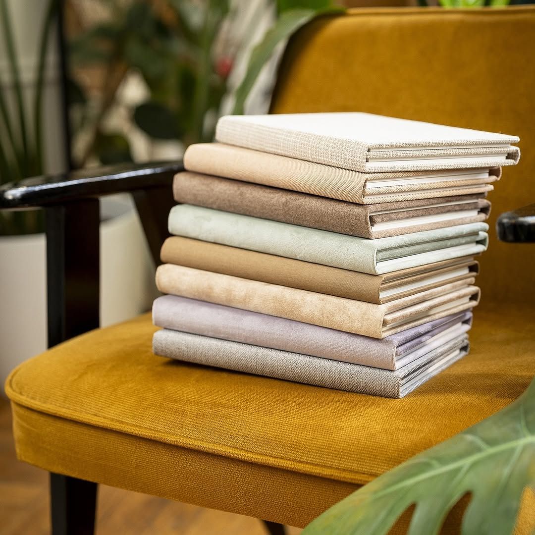 A yellow chair with a stack of books on it