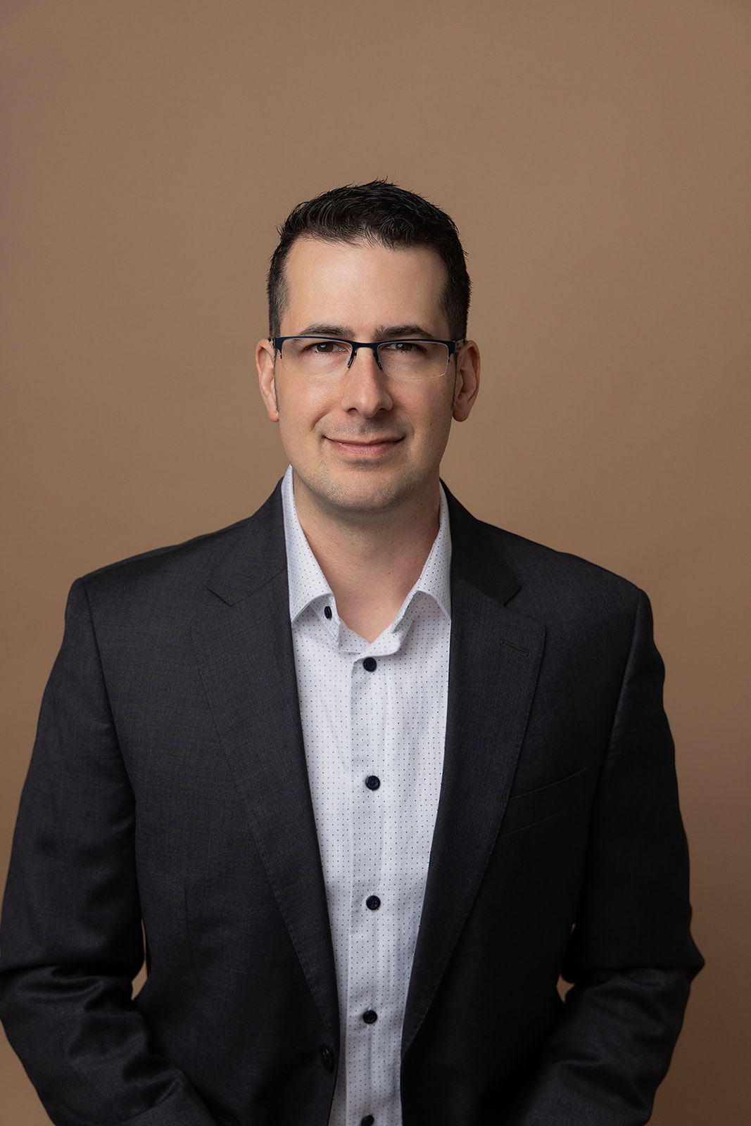 A man in a suit and glasses