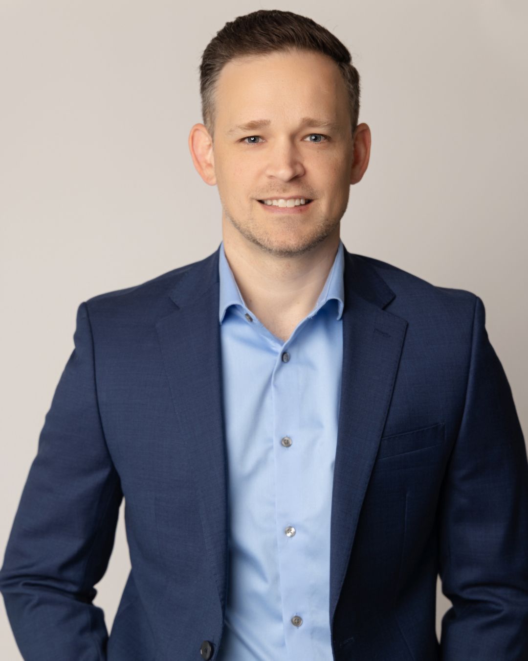 A man in a blue suit and blue shirt 