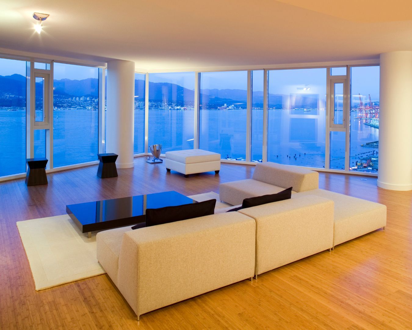 A living room with a view of the ocean and mountains