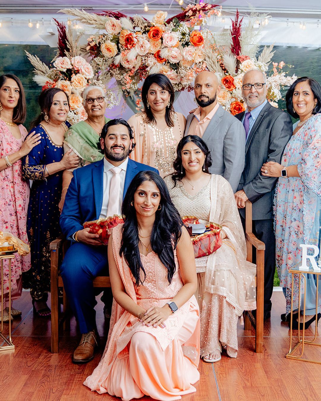 A group of people are posing for a picture at a wedding