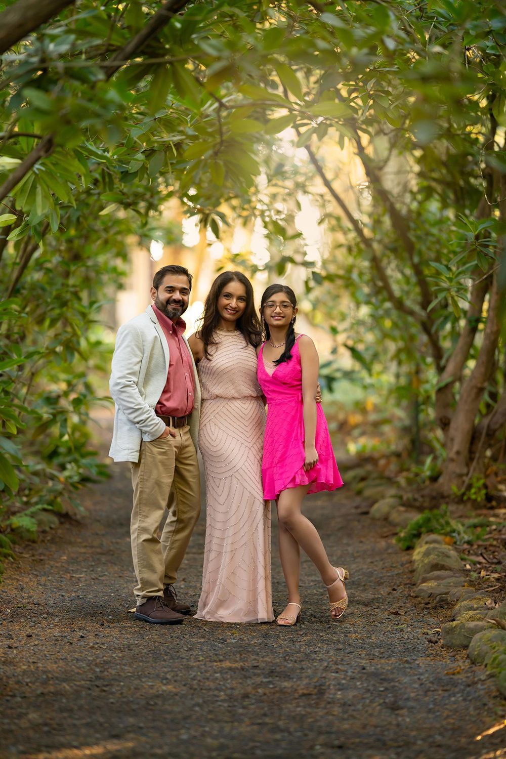 Family posing for a picture in the woods