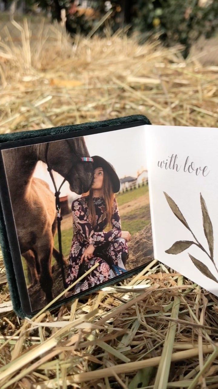 A picture frame with a picture of a woman sitting next to a horse