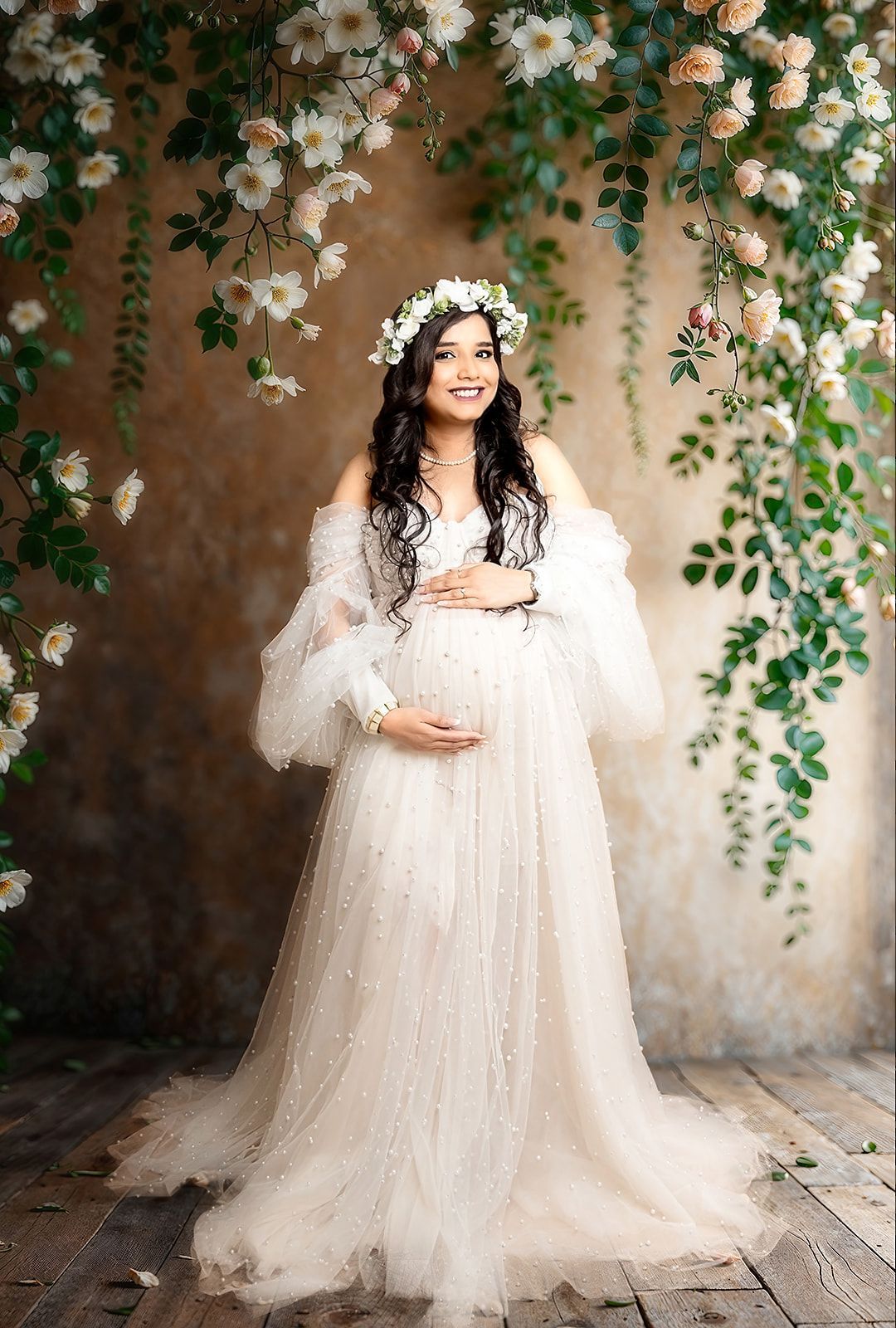 A pregnant woman is wearing a white dress and a flower crown