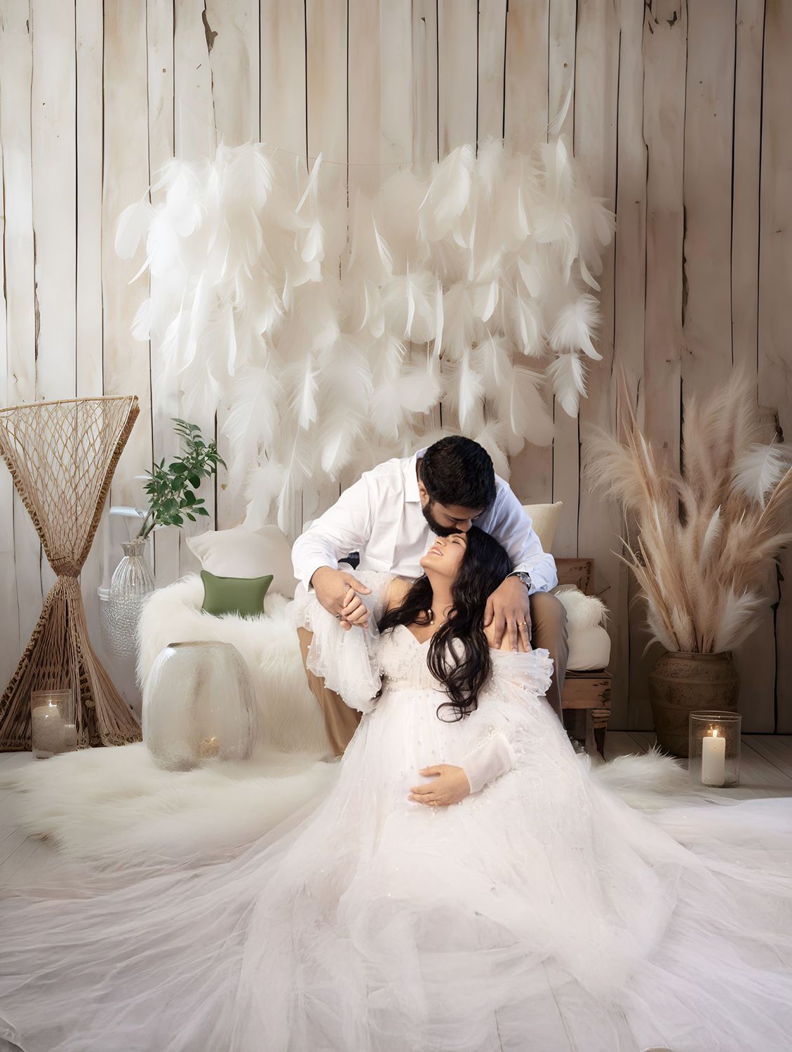 A man is kissing a pregnant woman in a white dress
