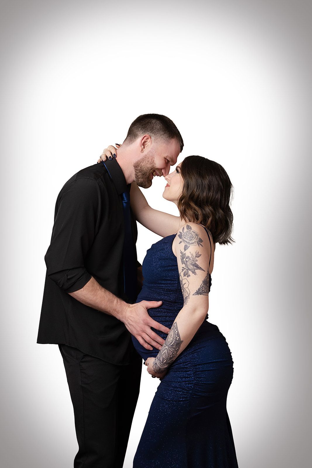 A man and a pregnant woman are standing next to each other