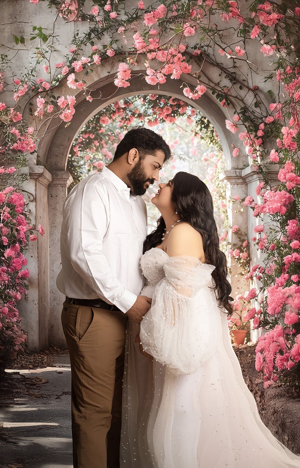 A man and a pregnant woman are standing next to each