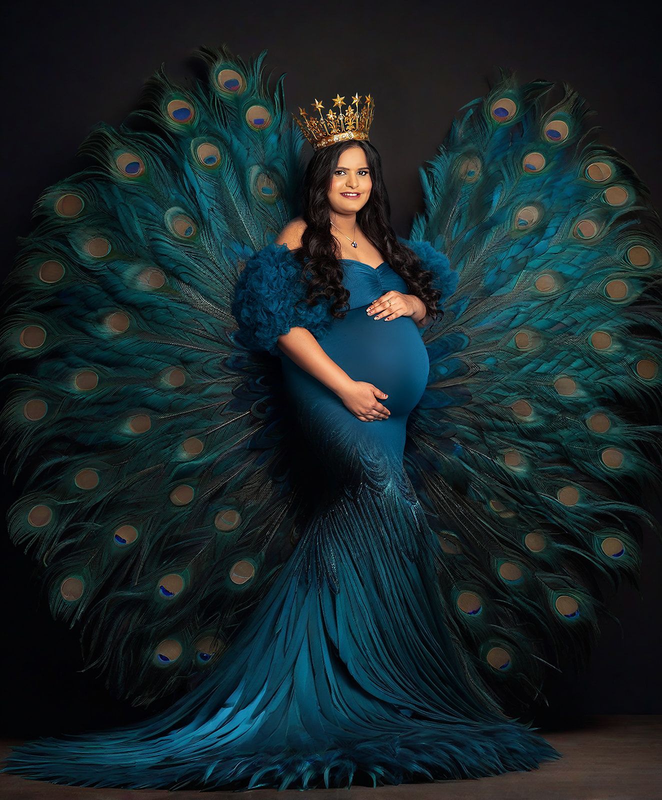 A pregnant woman is wearing a peacock costume and a crown.