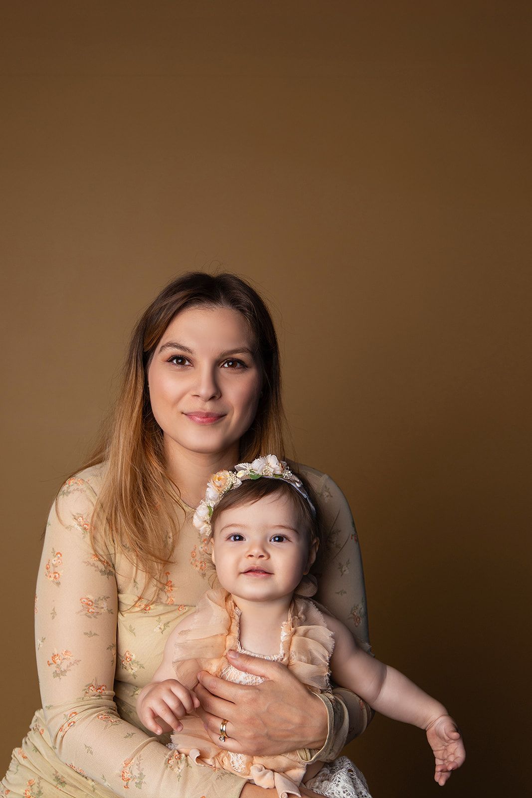 A woman is holding a baby girl in her arms.