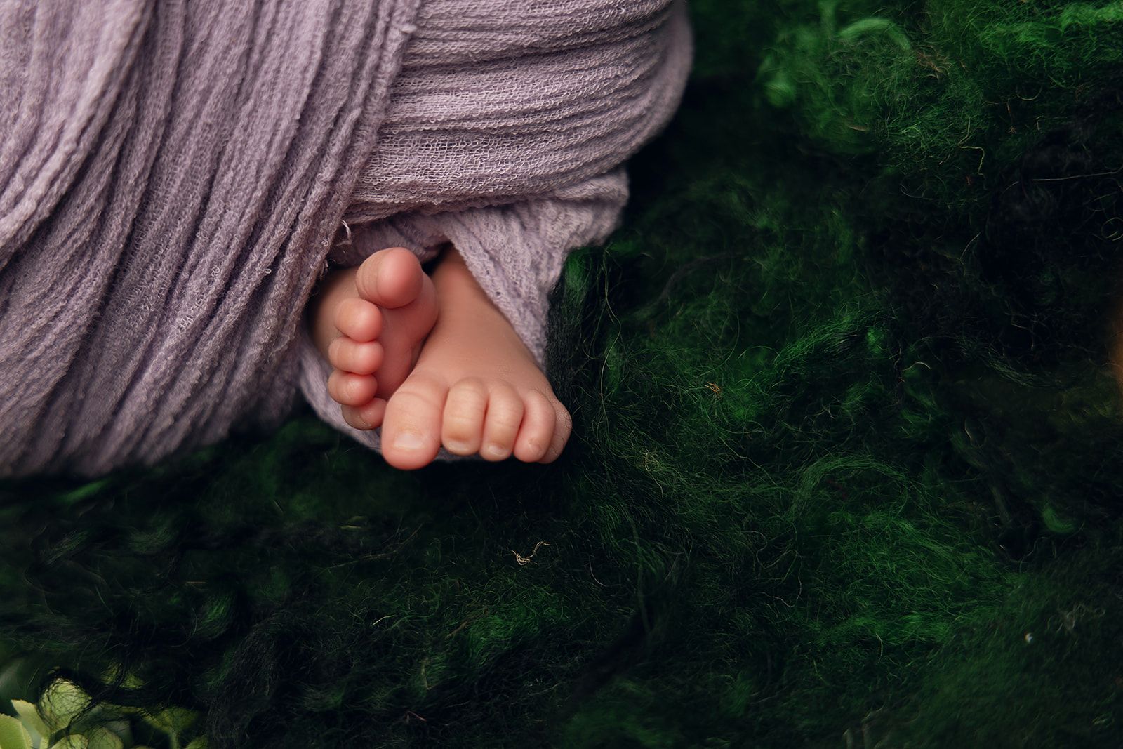 A close up of a baby 's feet wrapped in a blanket.