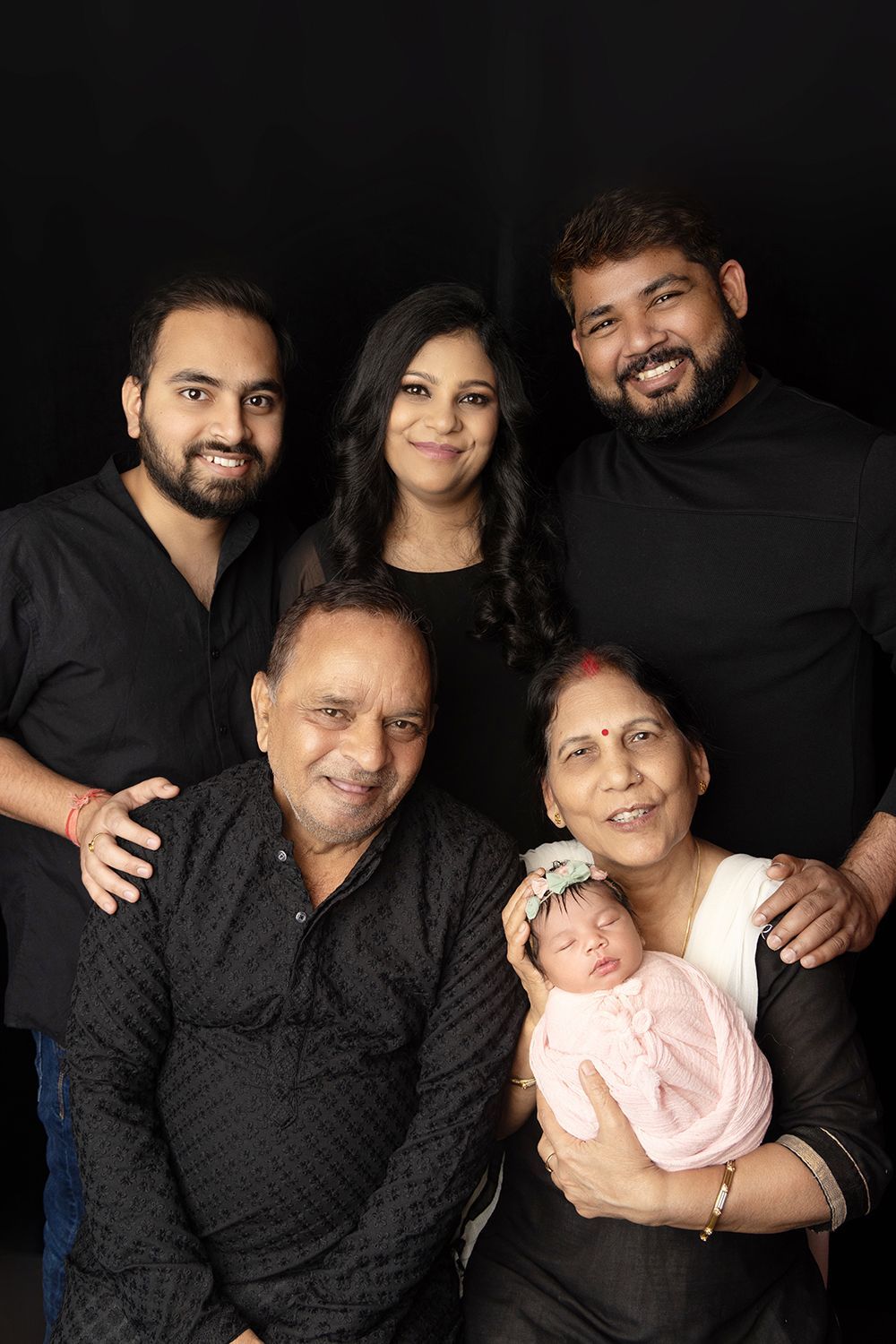 A newborn baby with family