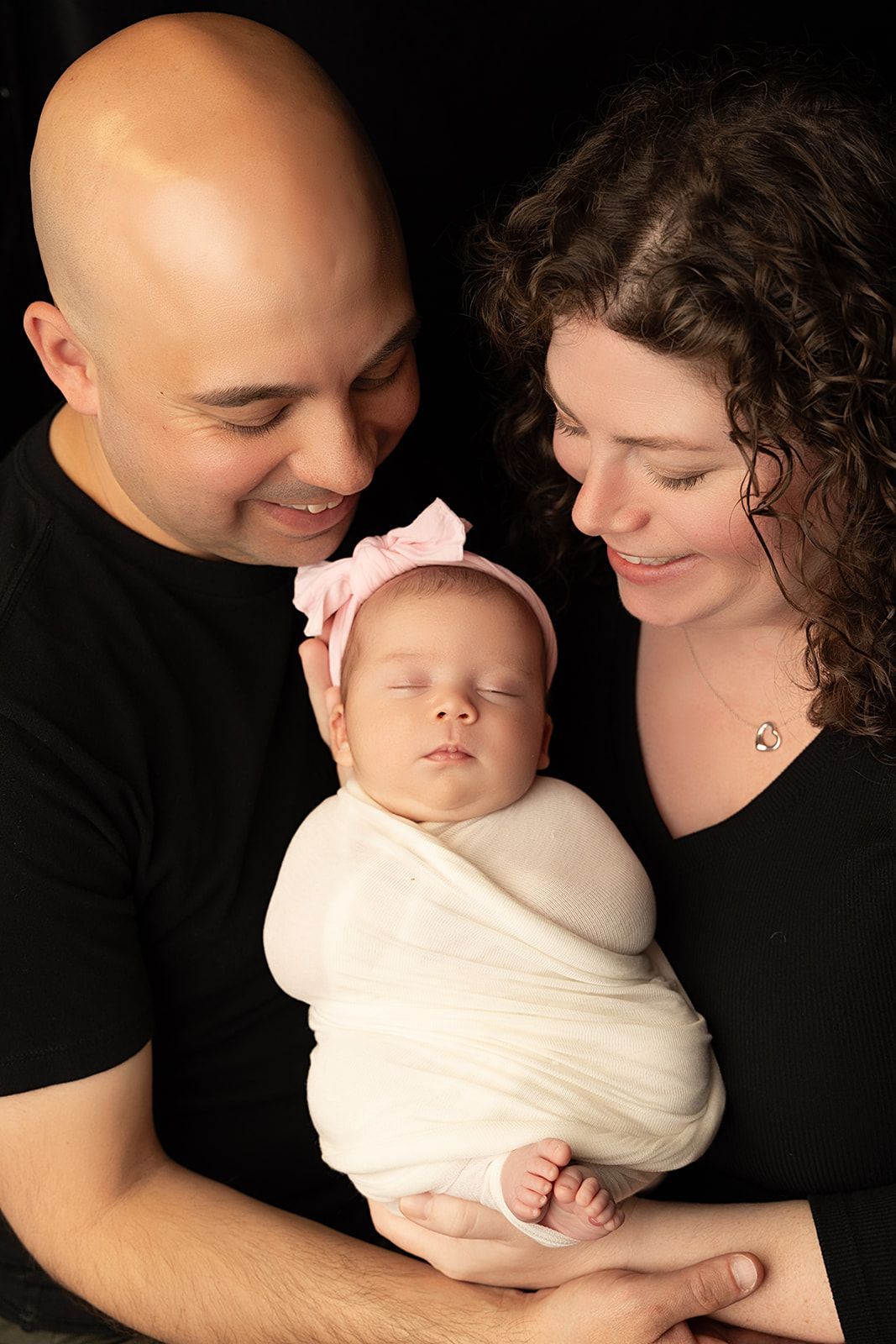 Happy parents holding newborn baby
